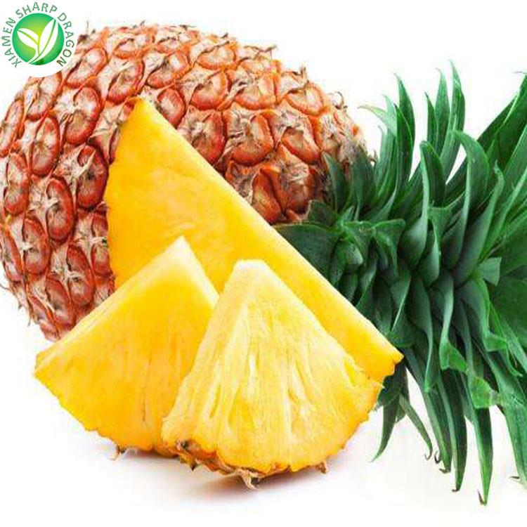Whole pineapple with freshly cut yellow pineapple wedges
